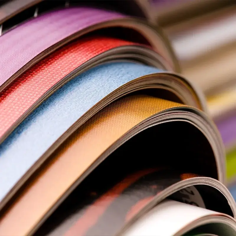 Close-up of curved, colourful printed catalogue pages