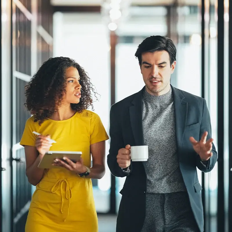 Two office colleagues speaking