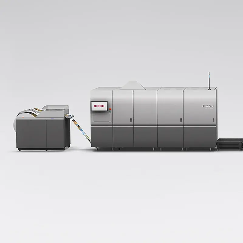 Original VC70000 base press with adjacent paper-feed equipment on grey backdrop