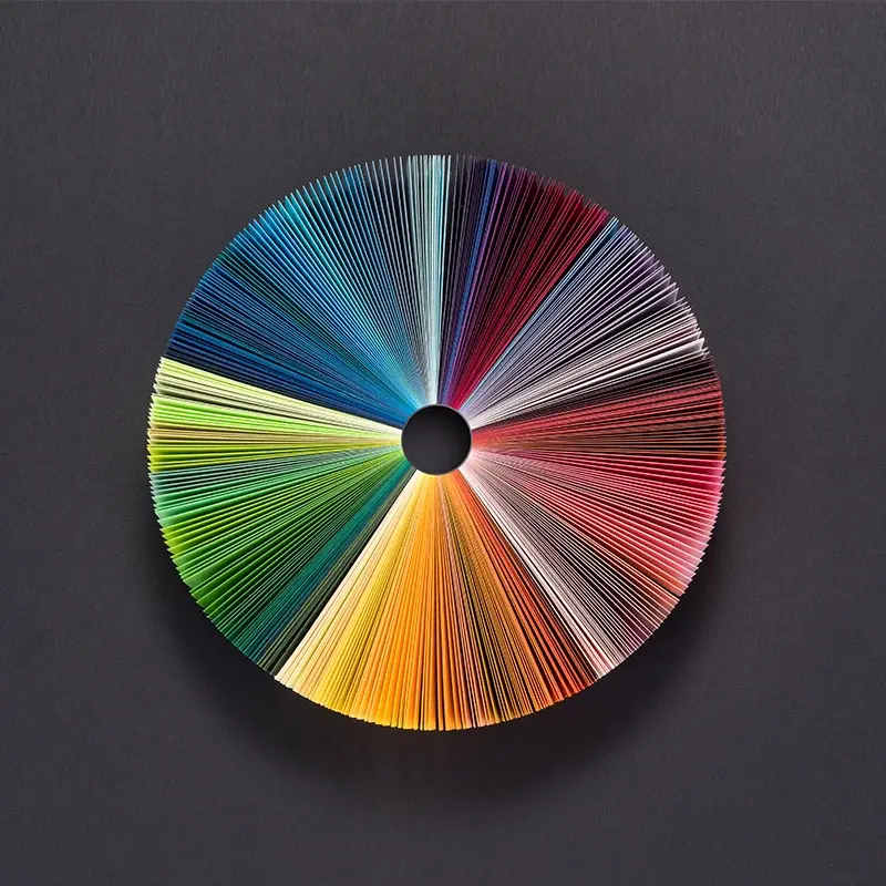 Circular fan of coloured printed papers