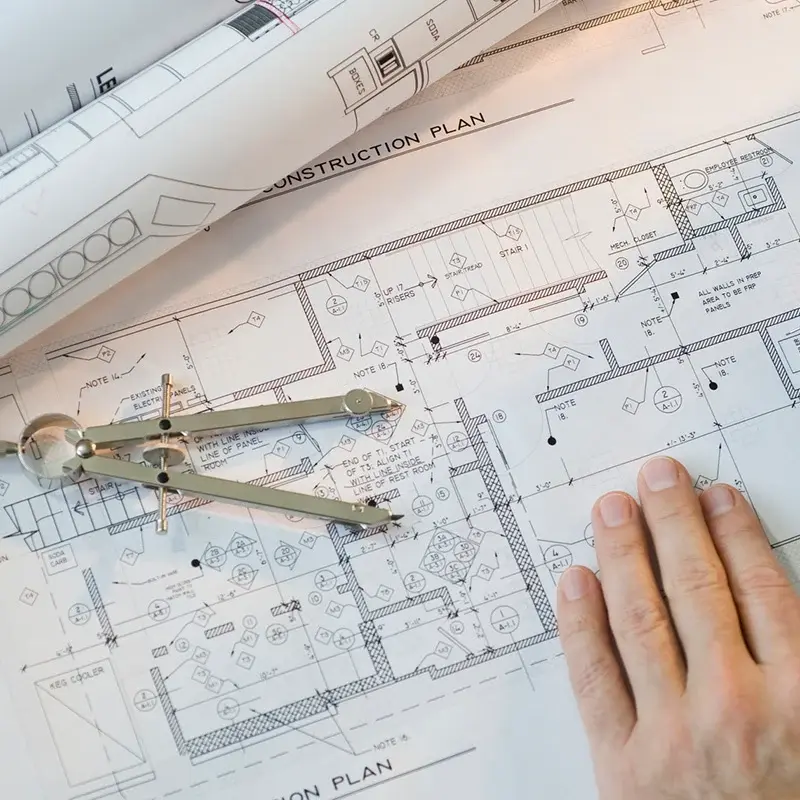 Printed architectural plan, pencil and dividers