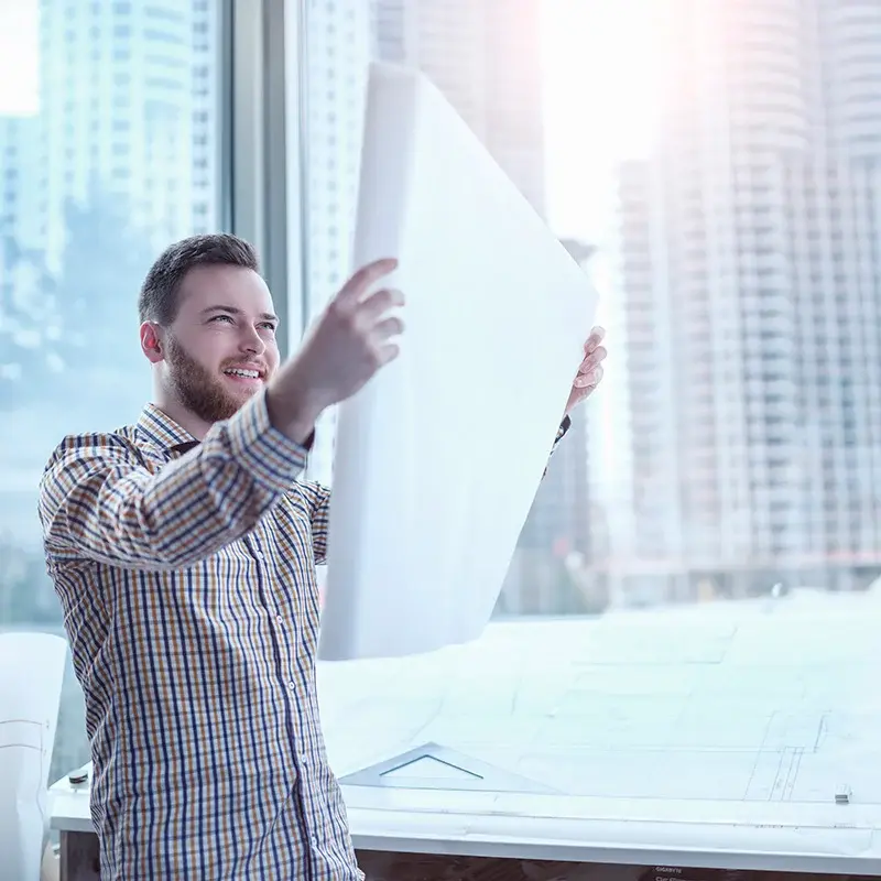 Person holding a large plan sheet