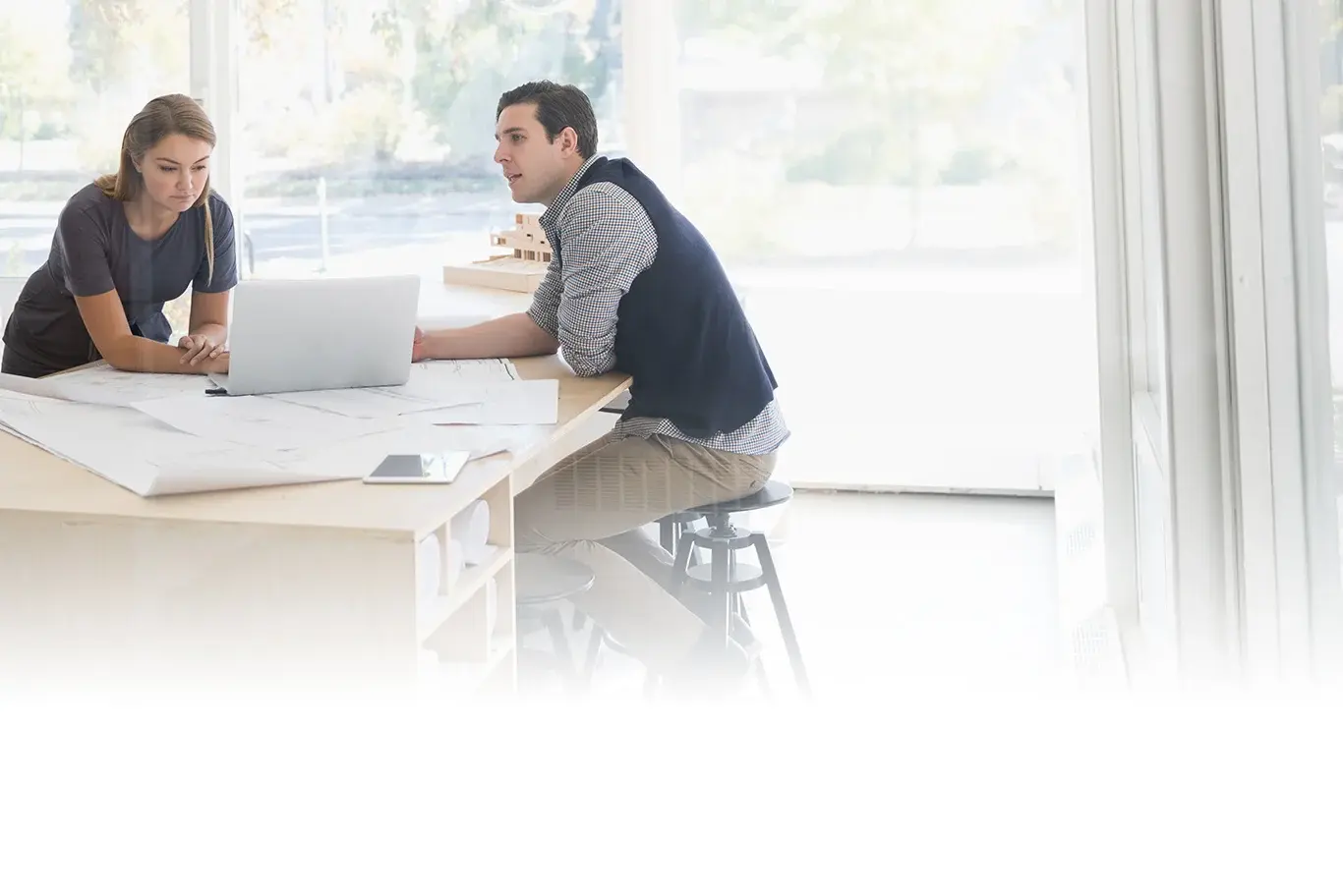 Two architects working at table