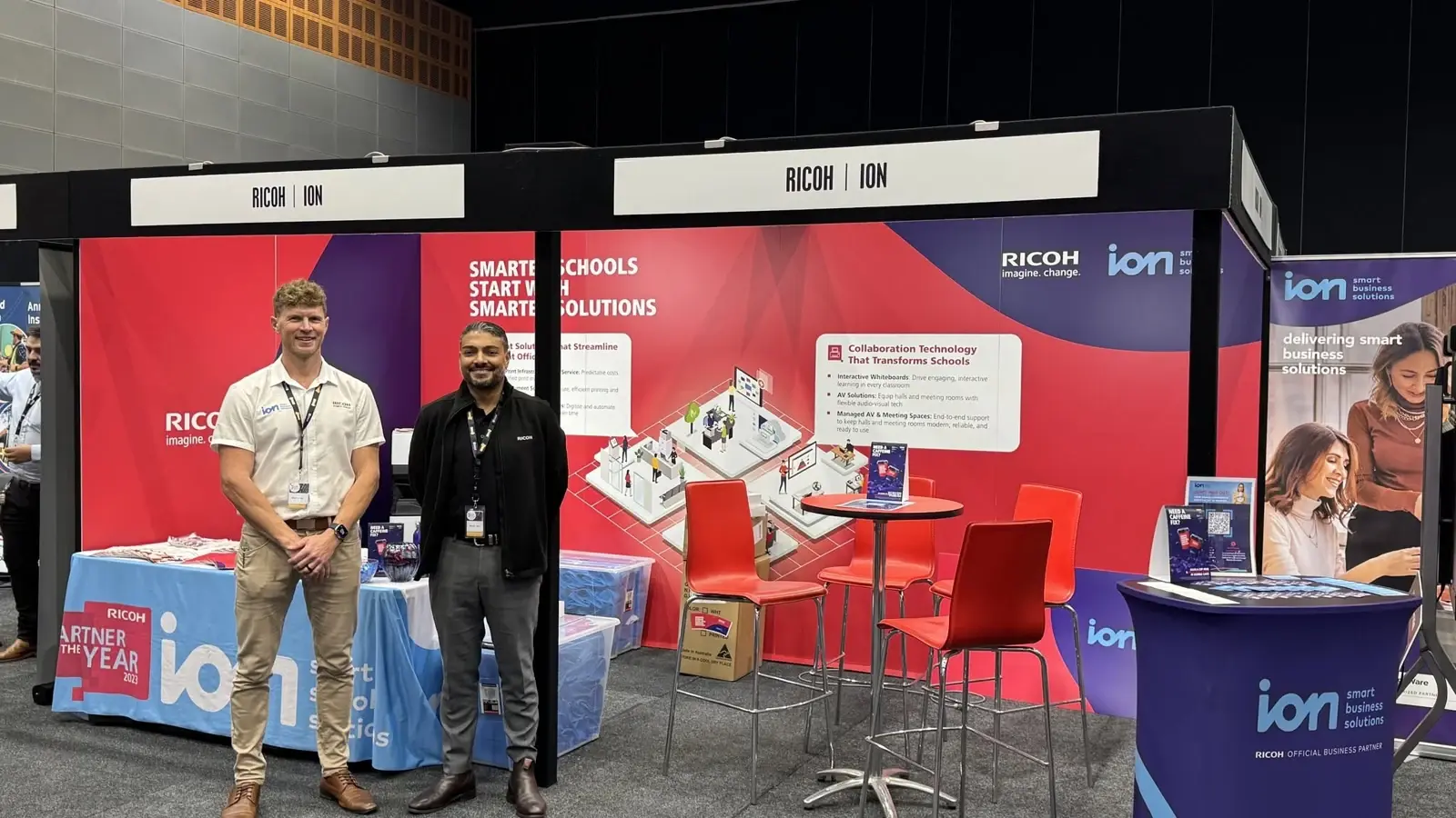 ion and Ricoh Australia representatives at their joint SBMAQ 2025 exhibition stand